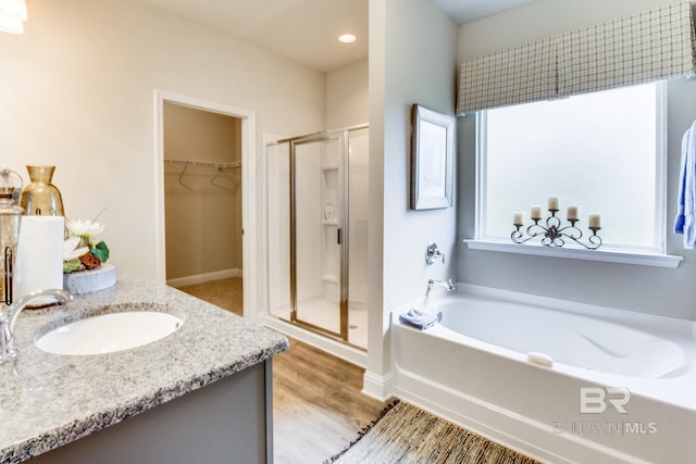 11547 Thistledown Loop, Spanish Fort, AL 36527 - full bath with a stall shower, a garden tub, wood finished floors, a spacious closet, and vanity