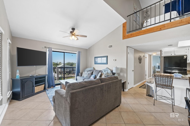 tiled living room with ceiling fan and lofted ceiling