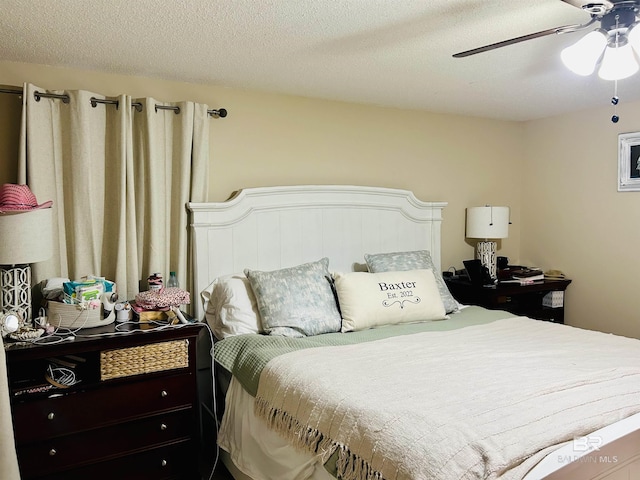 bedroom featuring a textured ceiling and ceiling fan