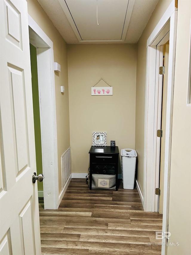 corridor with hardwood / wood-style floors