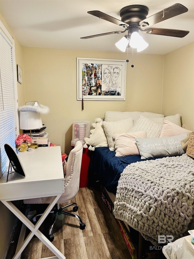 bedroom with ceiling fan and wood-type flooring