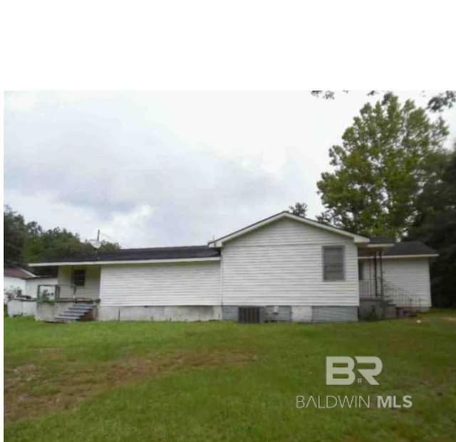 view of side of property with a lawn