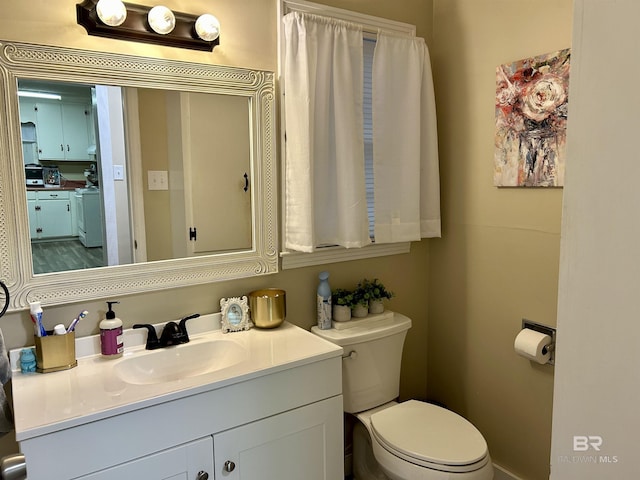 bathroom with toilet and vanity