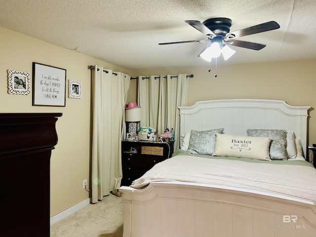 bedroom with light carpet, a textured ceiling, and ceiling fan