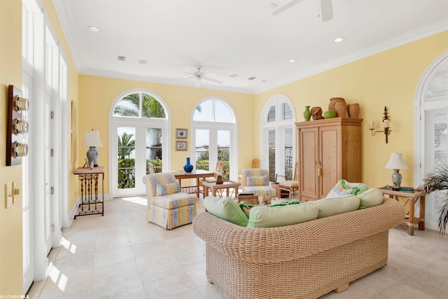 tiled living room featuring crown molding, french doors, and ceiling fan