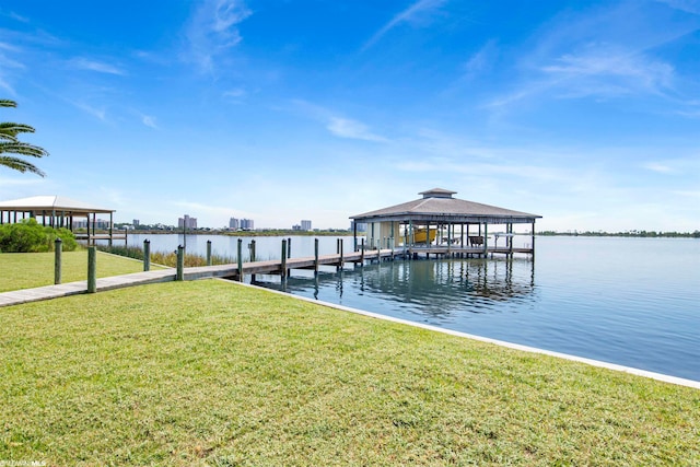 dock area with a water view and a yard