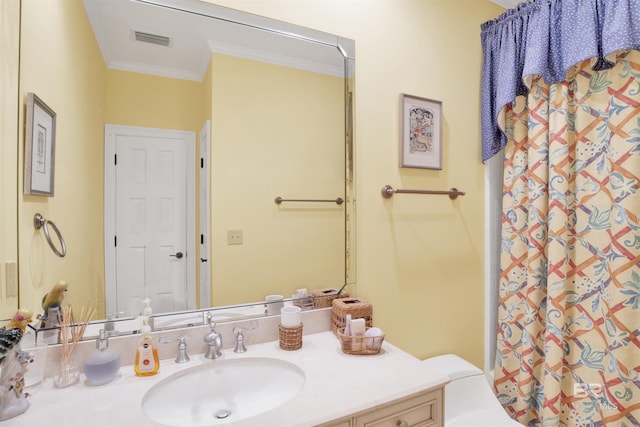 bathroom with vanity, toilet, crown molding, and walk in shower