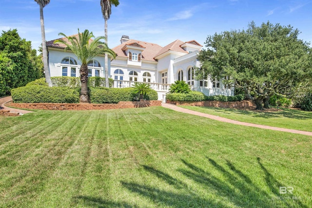 mediterranean / spanish-style house featuring a front lawn