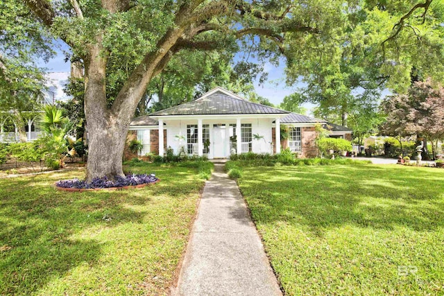 352 N Mobile St, Fairhope, AL 36532 - view of front facade with a front yard, metal roof, and a standing seam roof