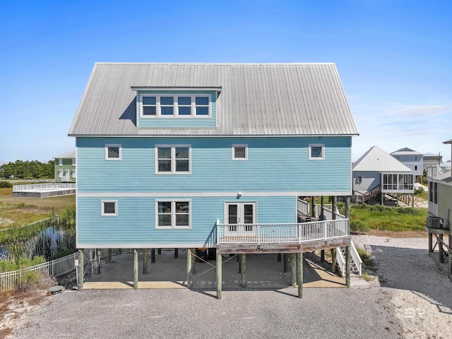 back of house featuring a carport