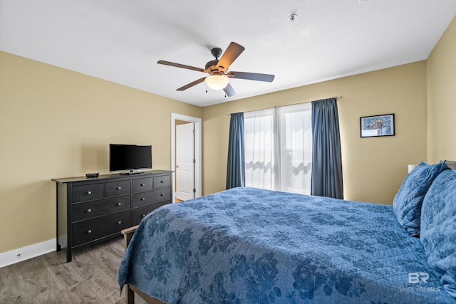 bedroom with ceiling fan and hardwood / wood-style flooring