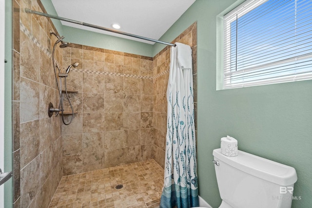 bathroom with toilet and curtained shower