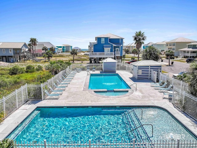 view of swimming pool featuring a community hot tub and a patio