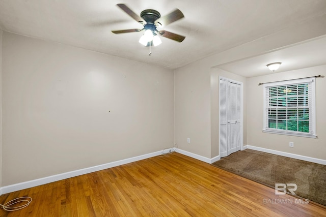 empty room with hardwood / wood-style flooring and ceiling fan