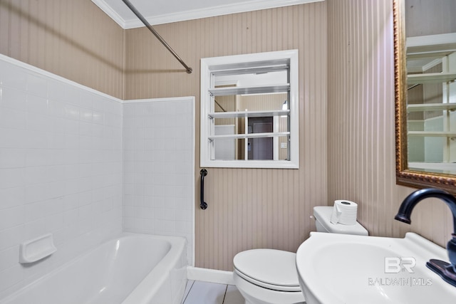 full bathroom with crown molding, sink, tiled shower / bath combo, toilet, and tile patterned flooring