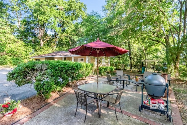 306 Thornton Pl, Mobile, AL 36609 - view of patio / terrace featuring outdoor dining space and view of scattered trees