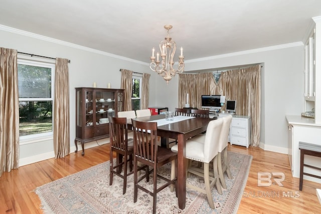 306 Thornton Pl, Mobile, AL 36609 - dining area featuring a chandelier, baseboards, light wood-style floors, and crown molding
