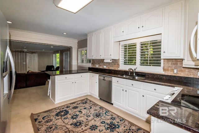 306 Thornton Pl, Mobile, AL 36609 - kitchen with stainless steel appliances, a sink, a peninsula, plenty of natural light, and ornamental molding