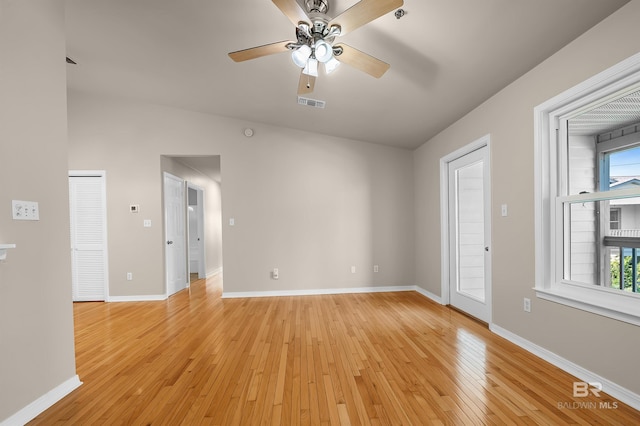 unfurnished room featuring light wood finished floors, baseboards, visible vents, and ceiling fan