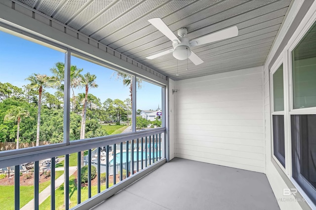 unfurnished sunroom with a ceiling fan