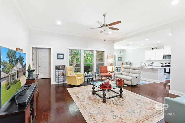 living room with dark hardwood / wood-style floors, sink, crown molding, and ceiling fan with notable chandelier