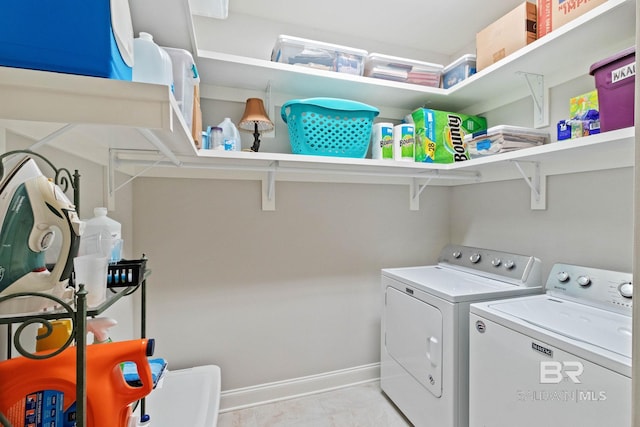 clothes washing area with washer and clothes dryer