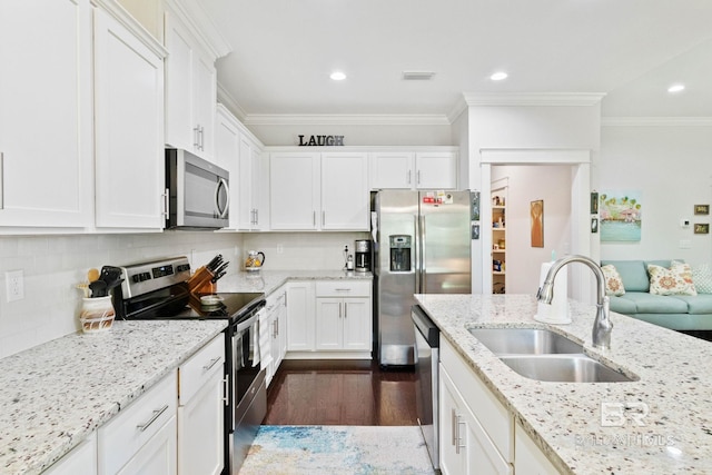 kitchen featuring light stone countertops, crown molding, sink, and stainless steel appliances