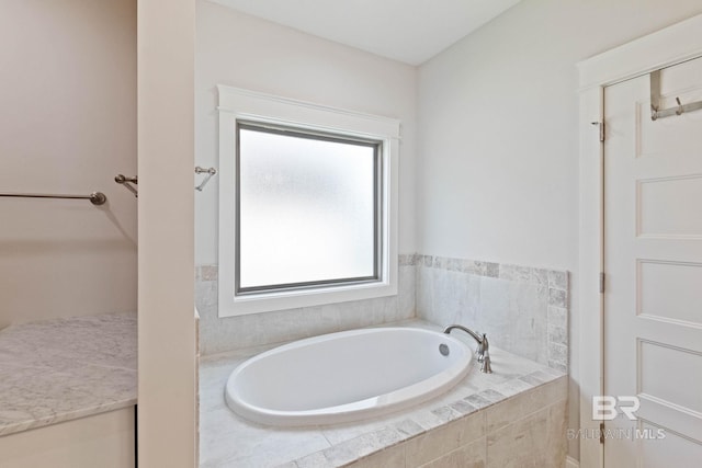 bathroom with tiled tub