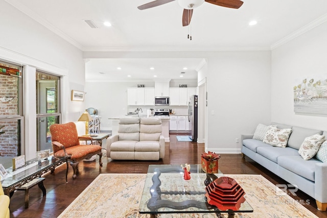 living room featuring dark hardwood / wood-style floors, ceiling fan, crown molding, and sink