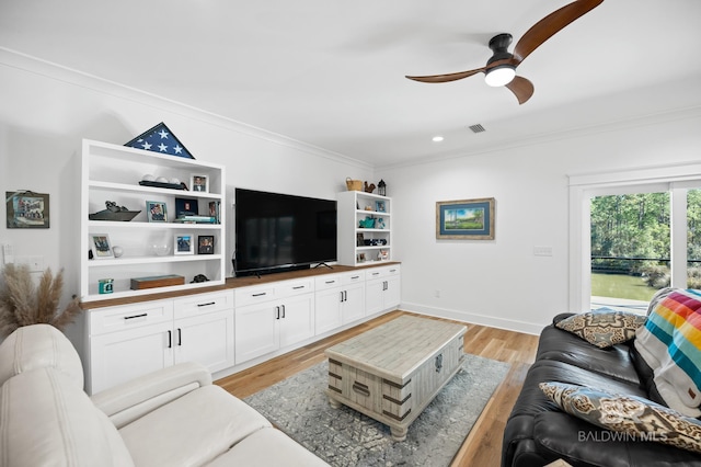 living room featuring light wood-type flooring, ceiling fan, and ornamental molding