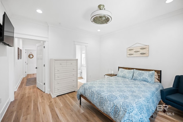 bedroom with light hardwood / wood-style flooring and ornamental molding