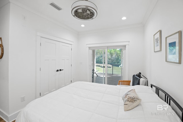 bedroom with ornamental molding, access to exterior, and a closet