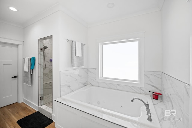 bathroom with independent shower and bath, hardwood / wood-style flooring, and crown molding