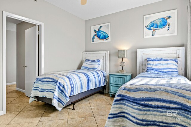 bedroom with ceiling fan and tile patterned floors
