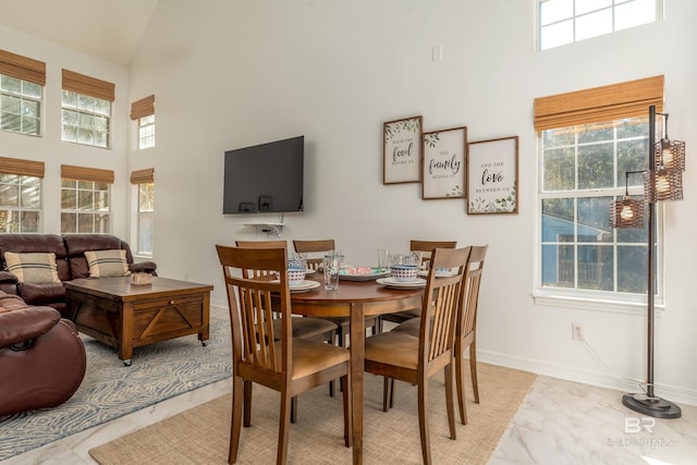 dining space with a towering ceiling