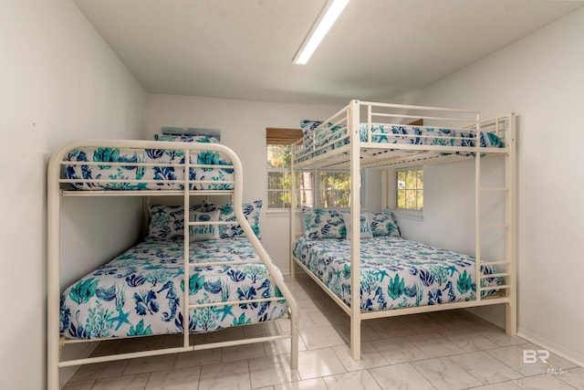 bedroom featuring tile patterned floors and multiple windows