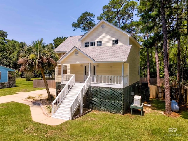 view of front of home with a porch and a front yard