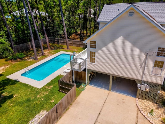 view of swimming pool with a patio area and a lawn