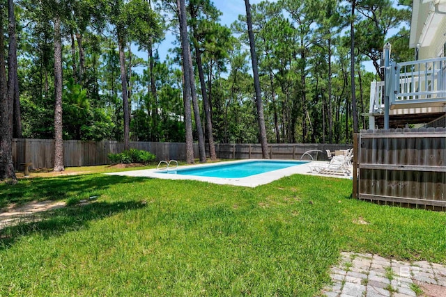 view of pool with a yard