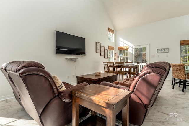 living room with high vaulted ceiling