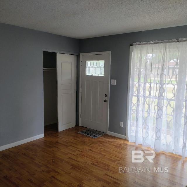 entryway with a textured ceiling and hardwood / wood-style floors