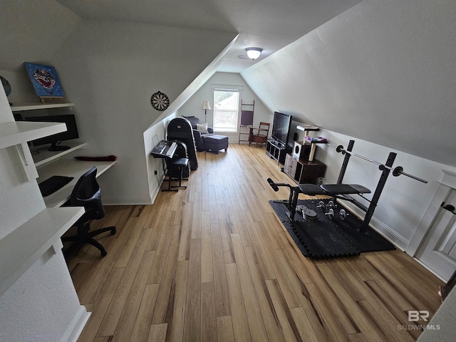 office area with lofted ceiling and wood finished floors