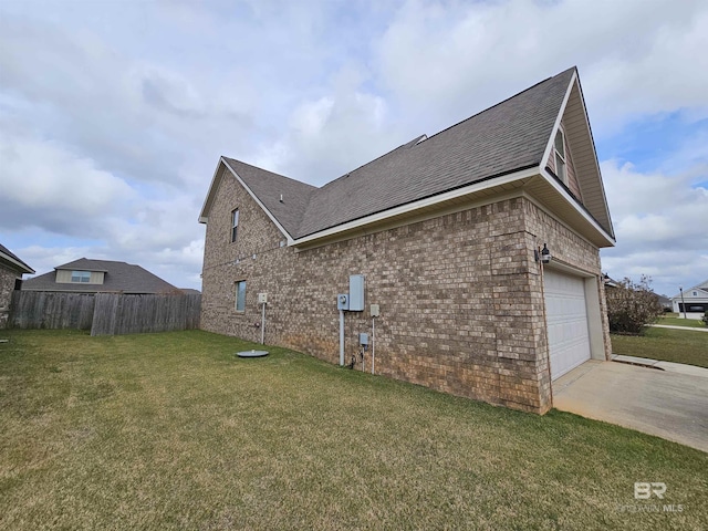 view of property exterior with brick siding, a yard, a shingled roof, concrete driveway, and fence