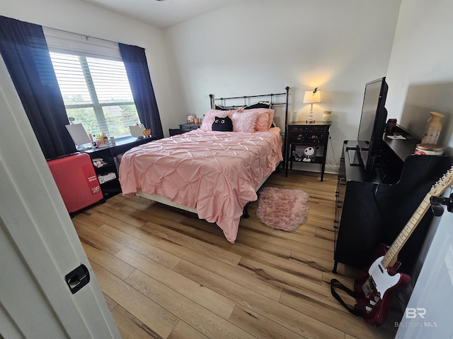 bedroom with light wood finished floors