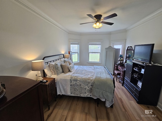 bedroom featuring ceiling fan, crown molding, and wood finished floors