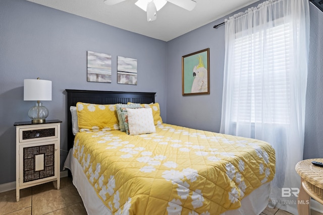 tiled bedroom featuring multiple windows and ceiling fan