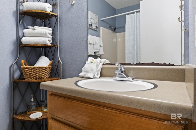 bathroom with a shower with curtain and vanity