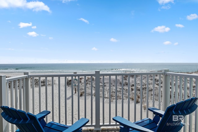 balcony featuring a water view and a beach view