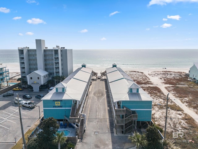 drone / aerial view featuring a view of the beach and a water view