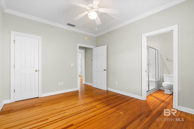 unfurnished bedroom featuring hardwood / wood-style floors, ceiling fan, crown molding, and ensuite bath